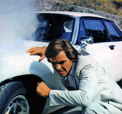 Ian Ogilvy Hiding Behind his white Jaguar XJS